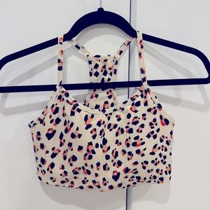 Cream and orange leopard print sports bra